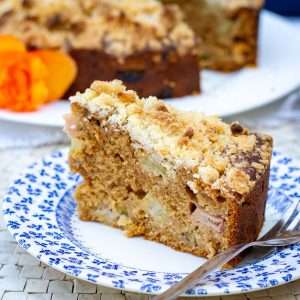 A slice of sourdough rhubarb cake on a small decoartive plate.