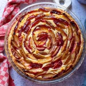 Plum Frangipane Tart on a grey surface.