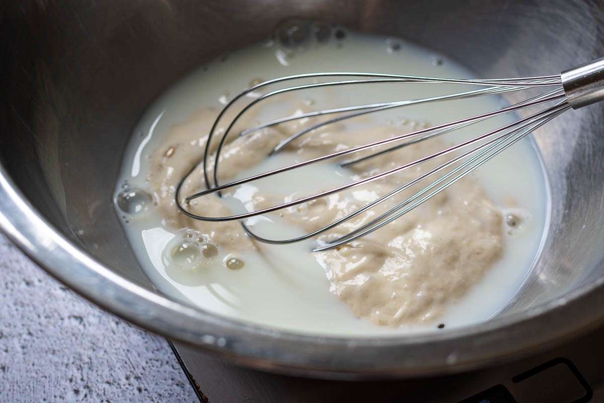 Whisking sourdough starter and milk together.