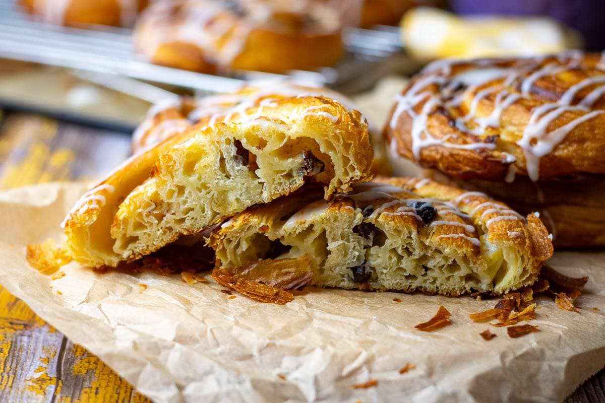 Sourdough Pain Aux raisins cut in half and placed on a piece of parchment paper.