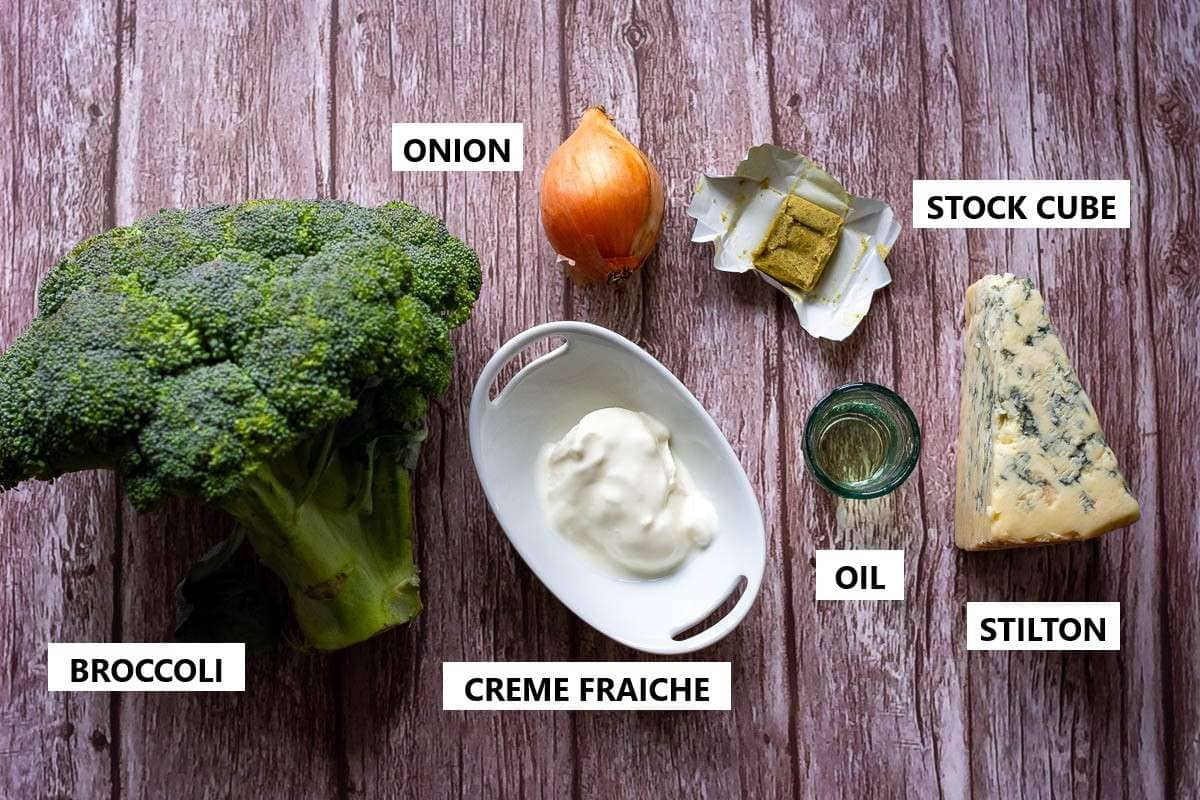 Ingredients for Broccoli and Stilton Soup on a wooden table.