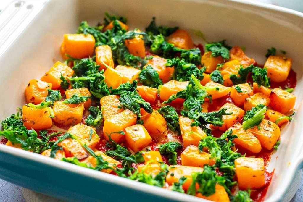 Spinach on top of the butternut squash layer.