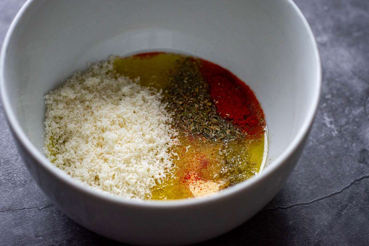 Marinade ingredients in a small white bowl.