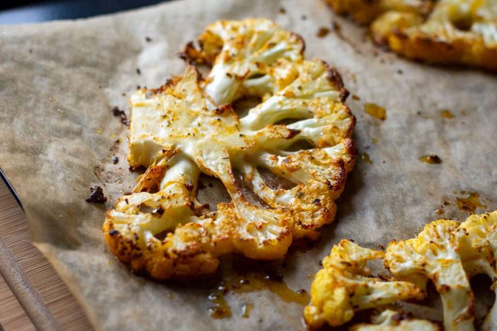 Roasted cauliflower steaks with browned edges.