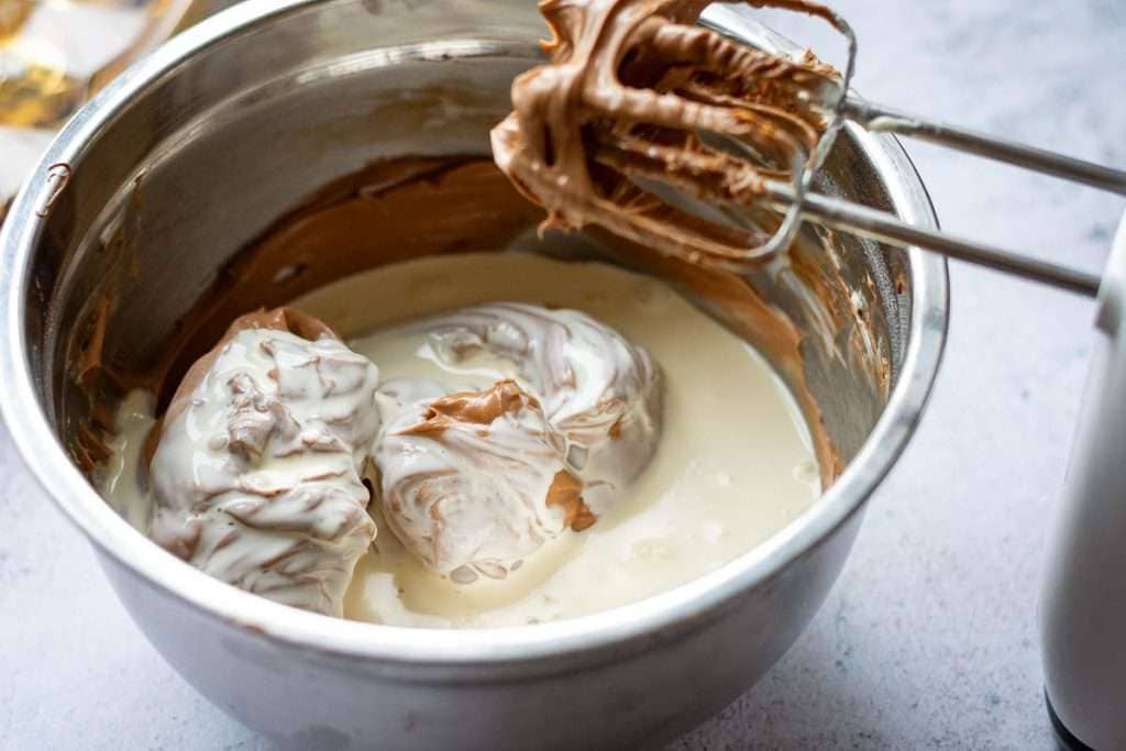 Cream poured into the chocolate and cream cheese mixture.