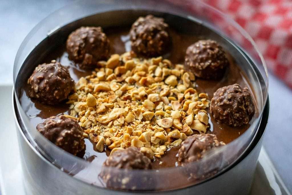 Chocolate cheeecake decorated with extra ferrero rocher chocolate and toasted hazelnuts.