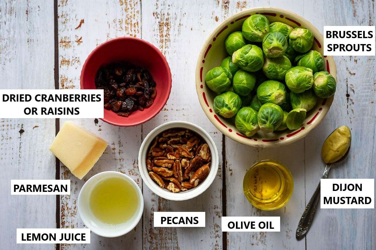 Ingredients for Brussels Sprouts and Parmesan Salad on a rustic wooden table.