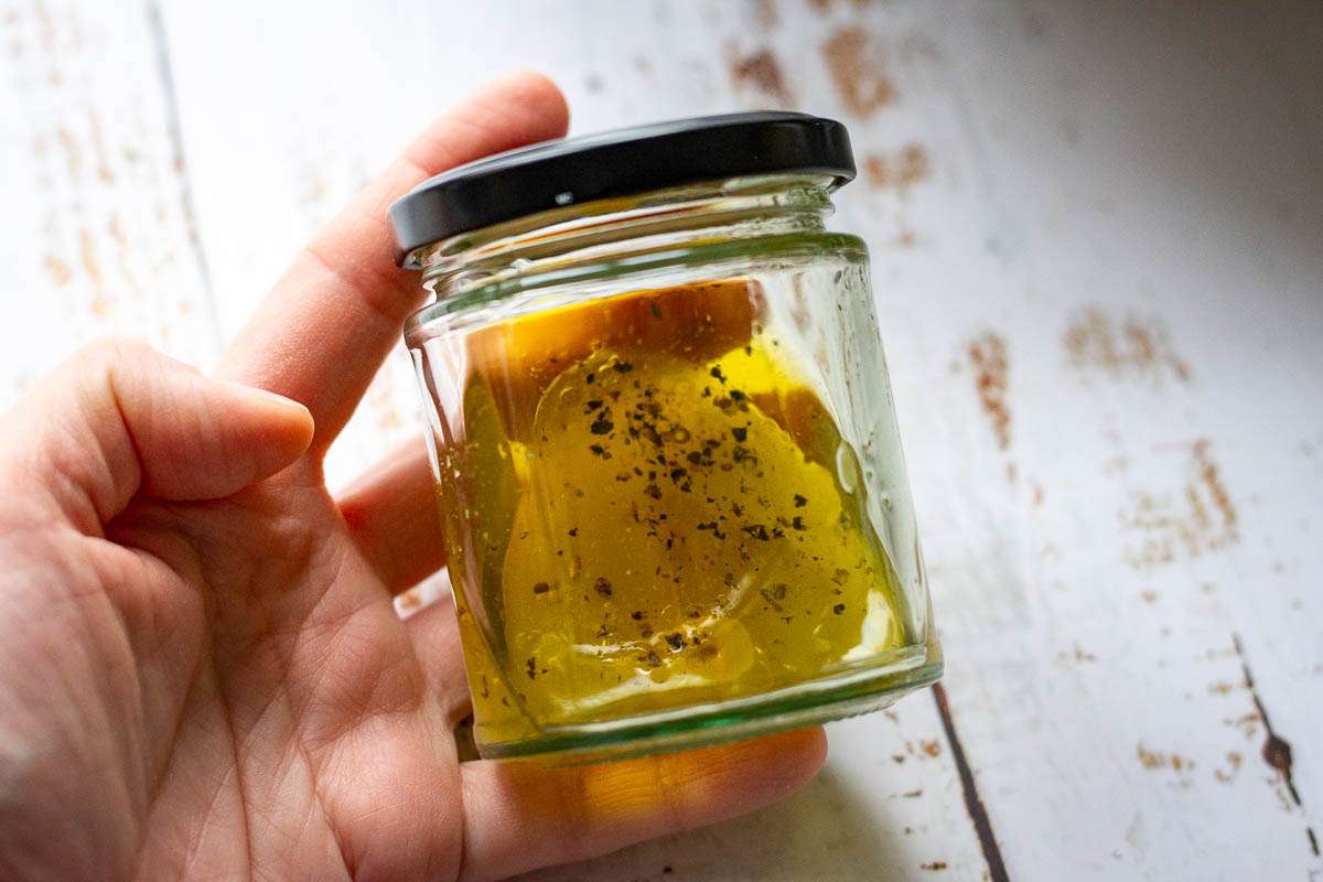 All the lemon dressing ingredients for the brussels sprout salad in a jar before shaking.