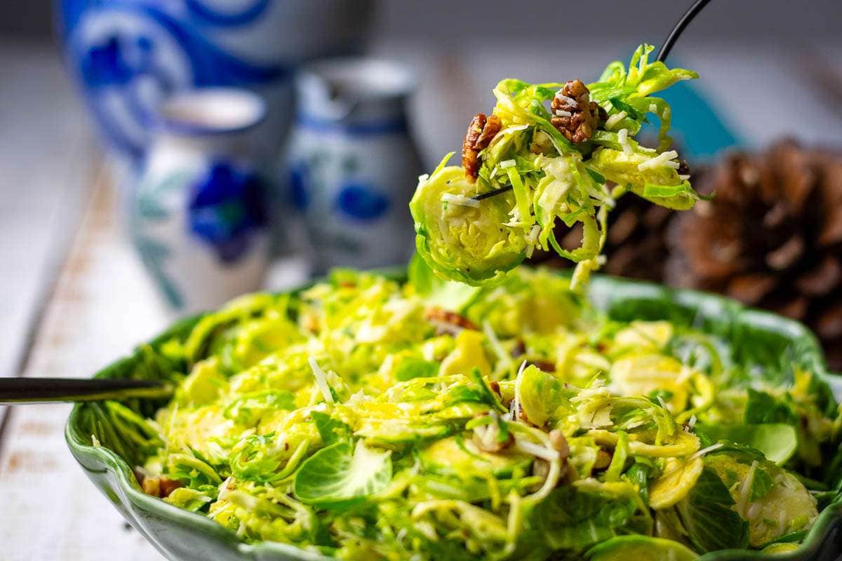 Brussels sprout salad being picked up by a fork.