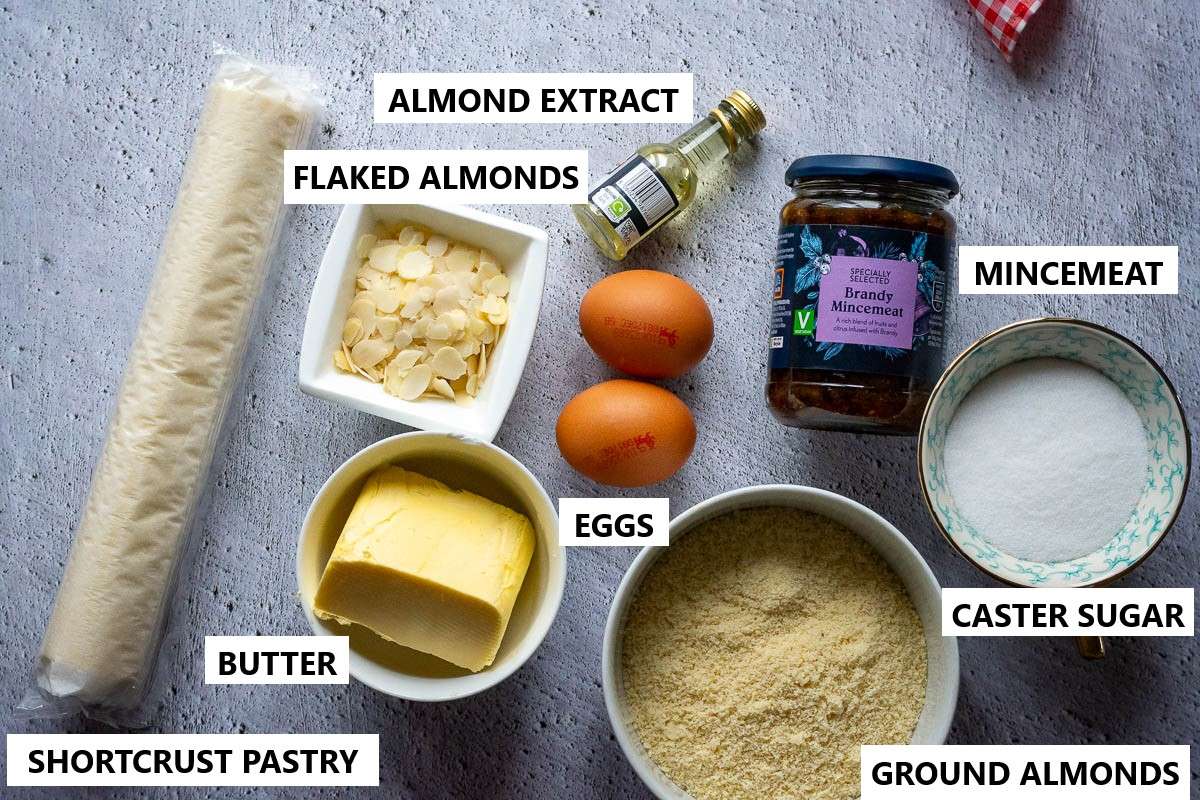 Ingredients for Christmas Frangipane tart on a grey surface.
