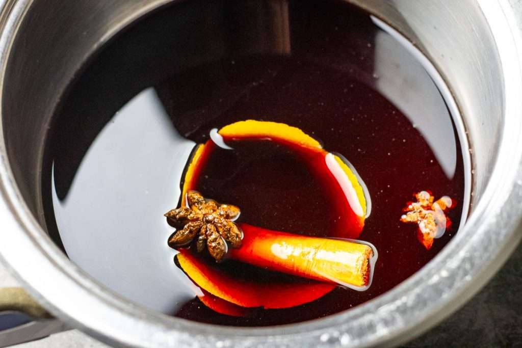 Spices and citrus peel simmering in port wine.