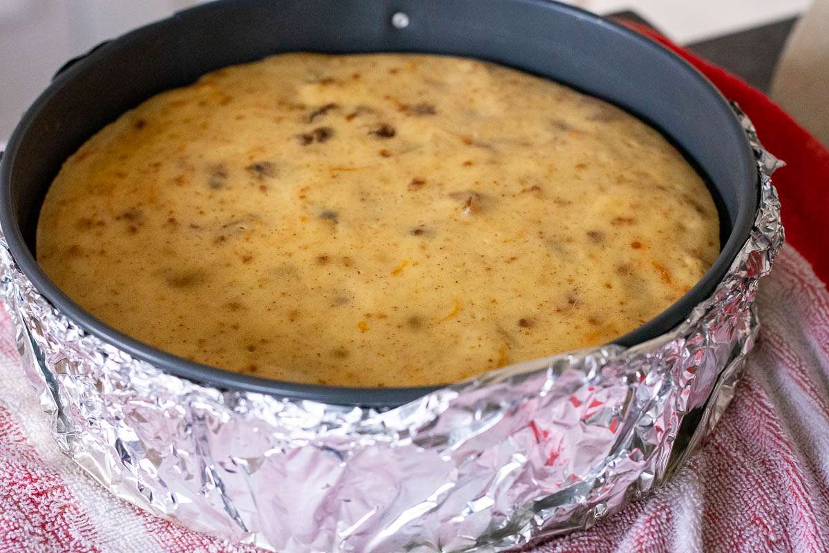 Christmas cake cheesecake cooling to room temperature in the springform pan.