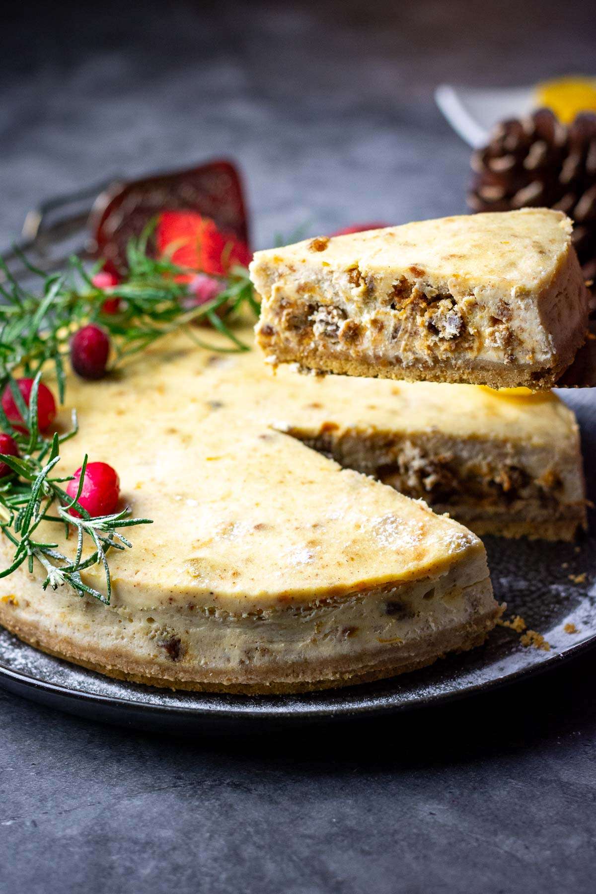 A slice of baked Christmas Cake Cheesecake being cut.