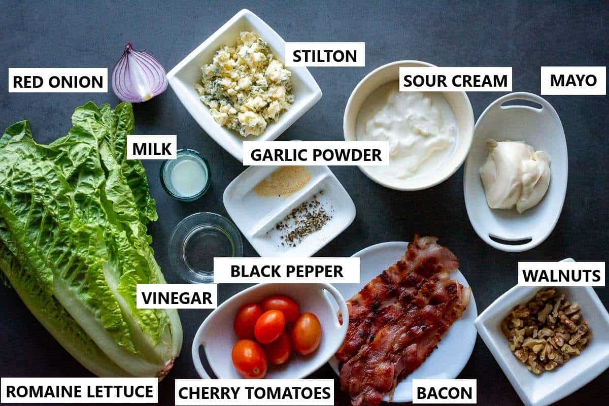 Ingredients for Romaine Wedge Salad on a dark grey surface.