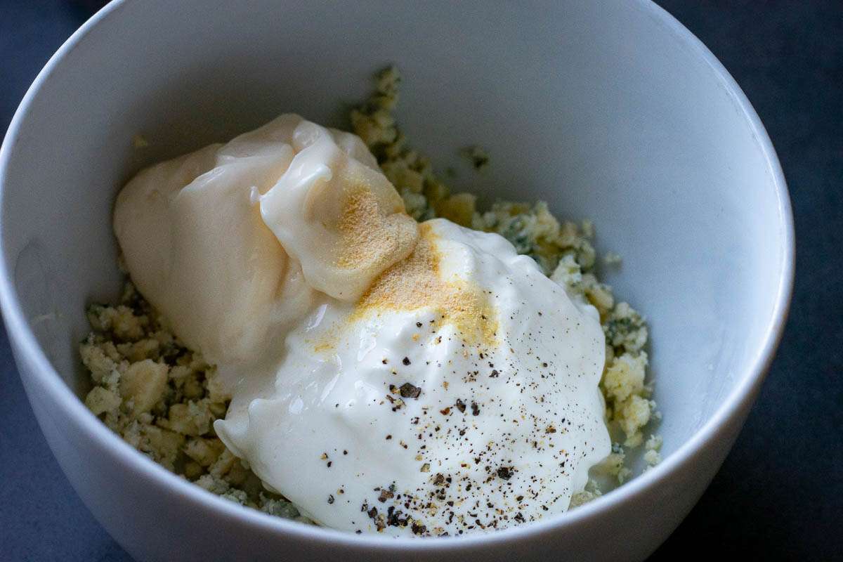 Blue cheese dressing ingredients in a small white bowl.