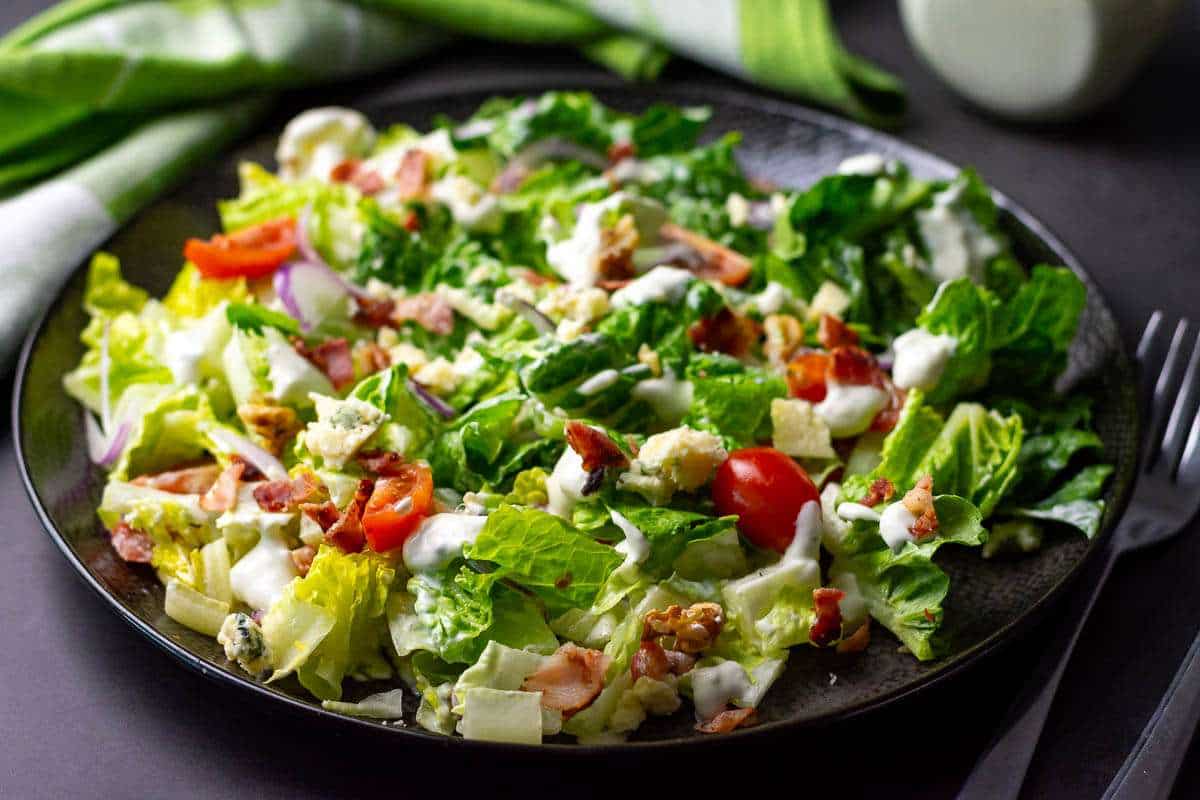 Romaine salad with cherry toatoes, bacon, and blue cheese dressing.