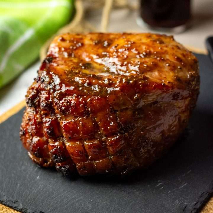 Slow Cooker Gammon in Cola on a black slate board.