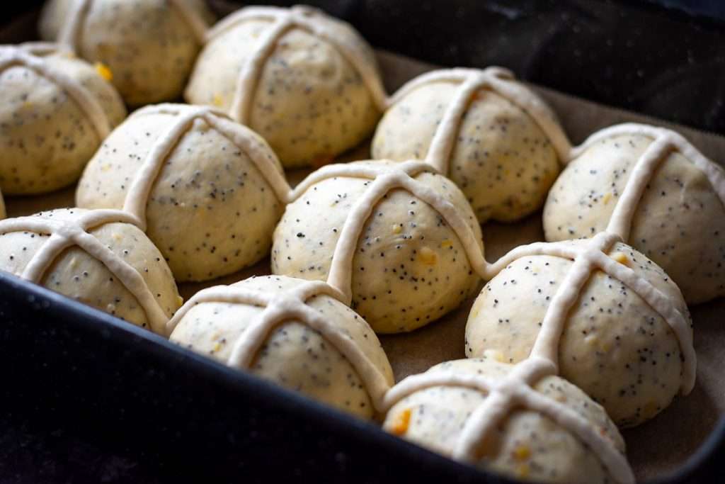 Crosses piped on the proofed buns.
