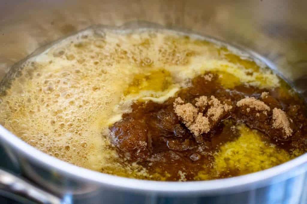 Butter, golden syrup and sugar melting in a pan.
