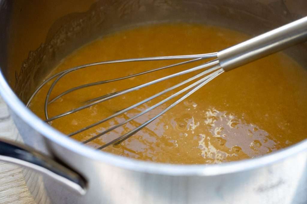 Sourdough discard beaten into the butter and syrup mixture using a balloon whisk.