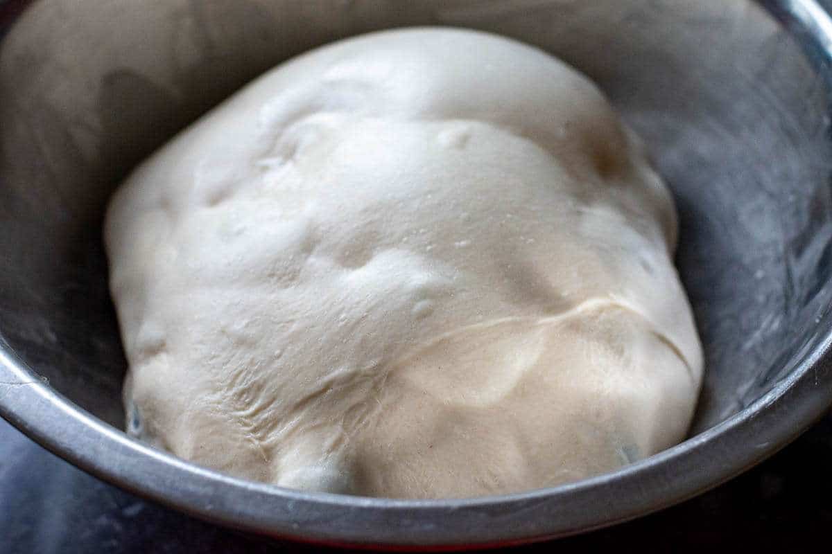 Lemon and Blueberry Sourdough bulk fermenting in a large mixing bowl.