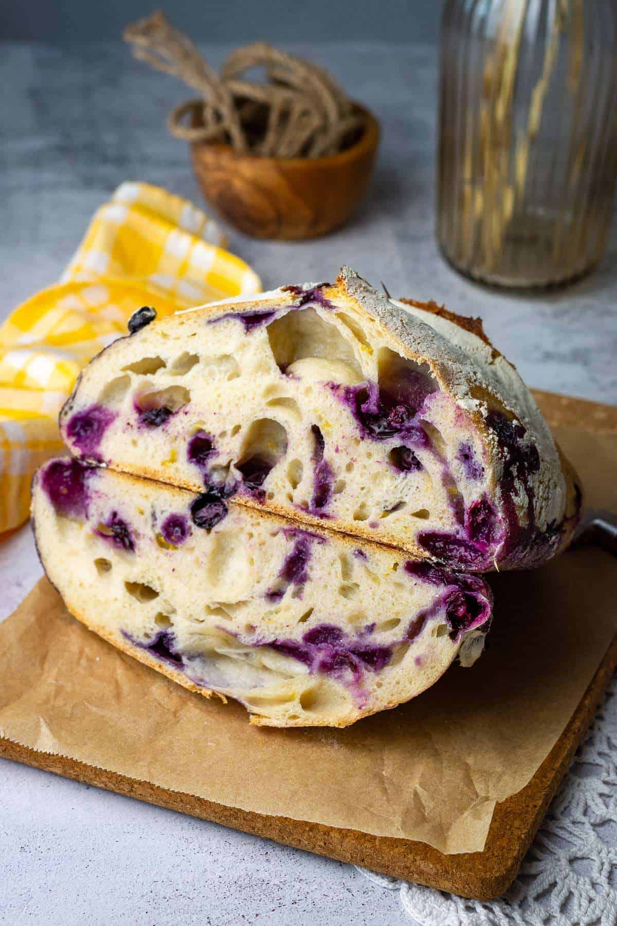 Two halves of lemon and blueberry sourdough bread stacked on top of each other.