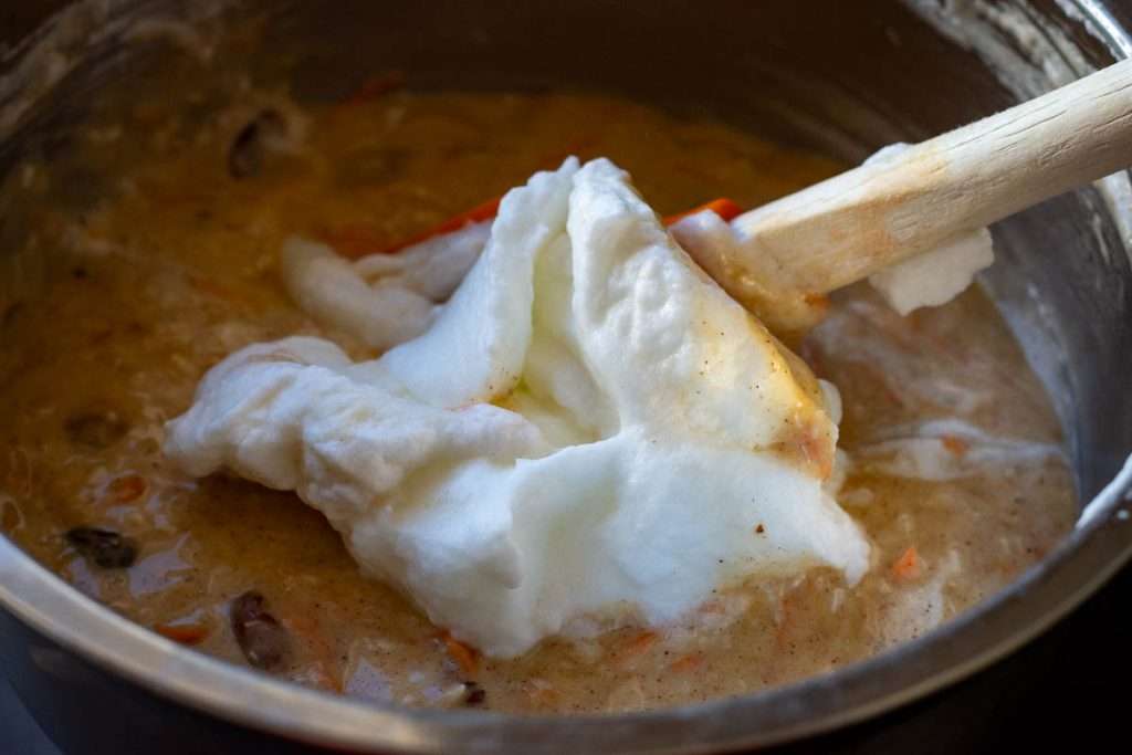 Folding in the egg whites into the sourdough cake batter.