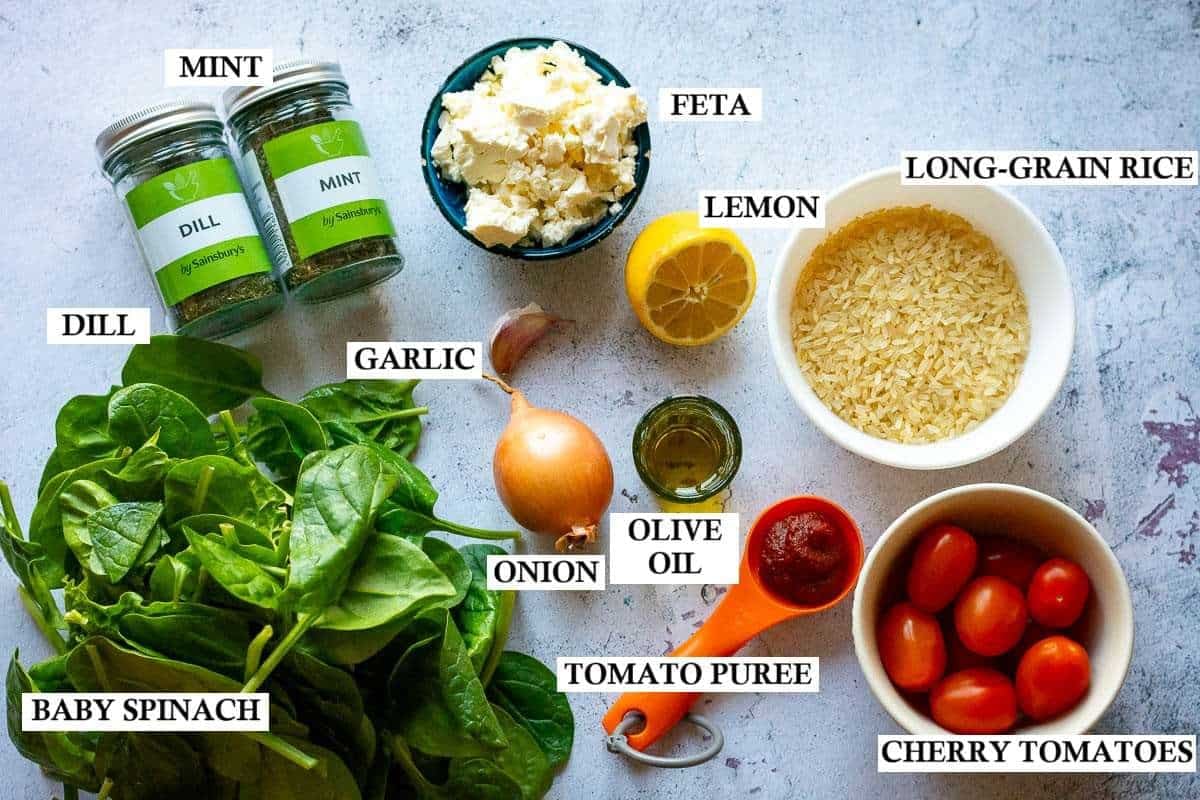 Ingredients for Greek Spinach Rice on a light grey surface.