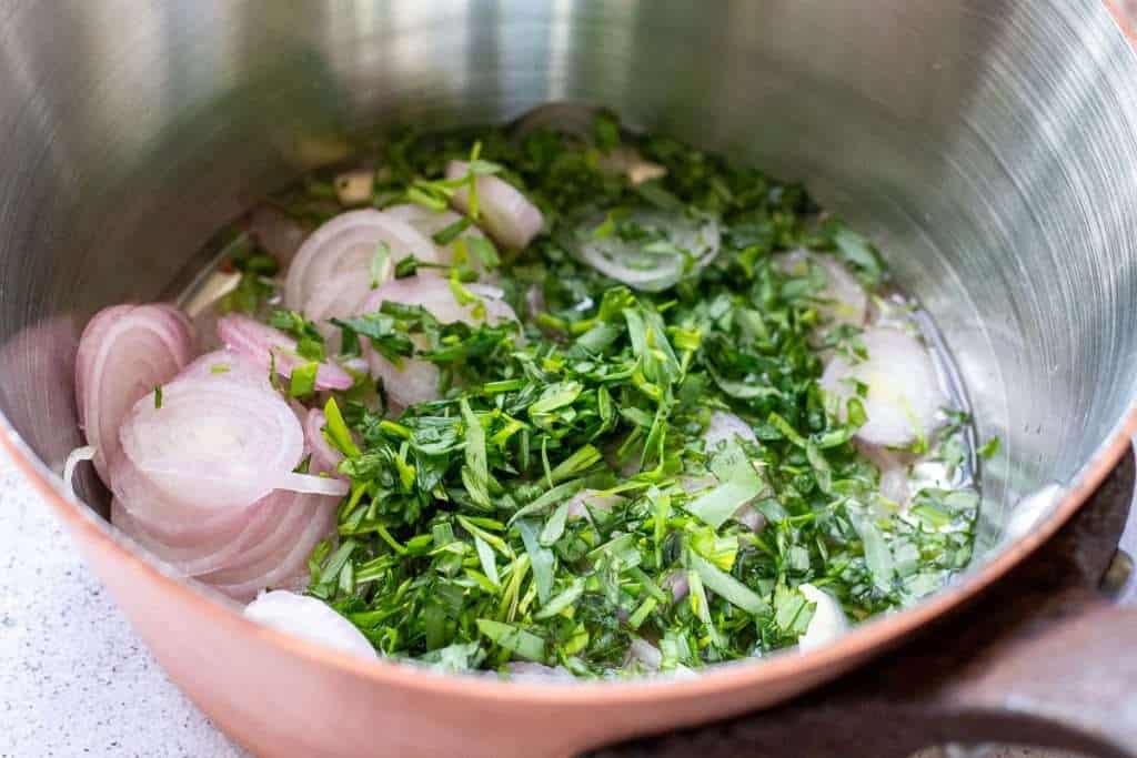 Shallots, tarragon, viengar and lemon juice in a small copper pan.