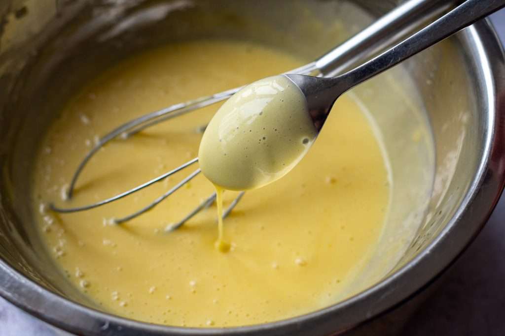 Creamy bearnaise sauce is smooth and glossy and coats the back of the spoon.