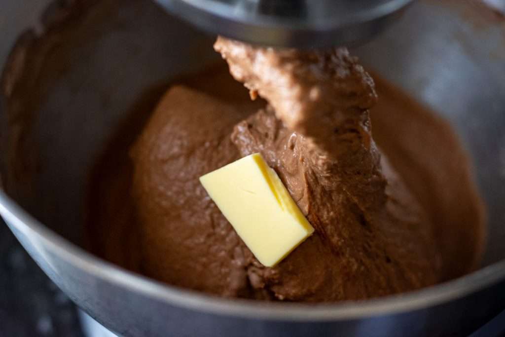 A slither of butter added to the dough in the running stand mixer.