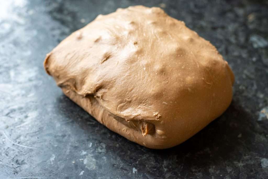 Laminating cherries and chocolate chips into the sourodugh hot cross bun dough.