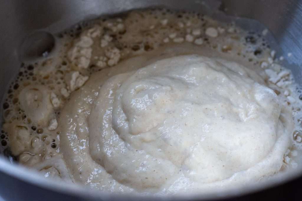 Garlic knot dough ingredients apart form butter in a bowl of a stand mixer.