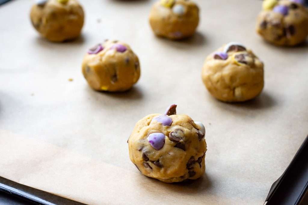 Balls of cookie dough topped with mini eggs.