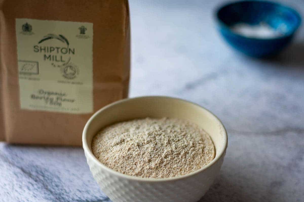 Barley flour in a small white bowl.