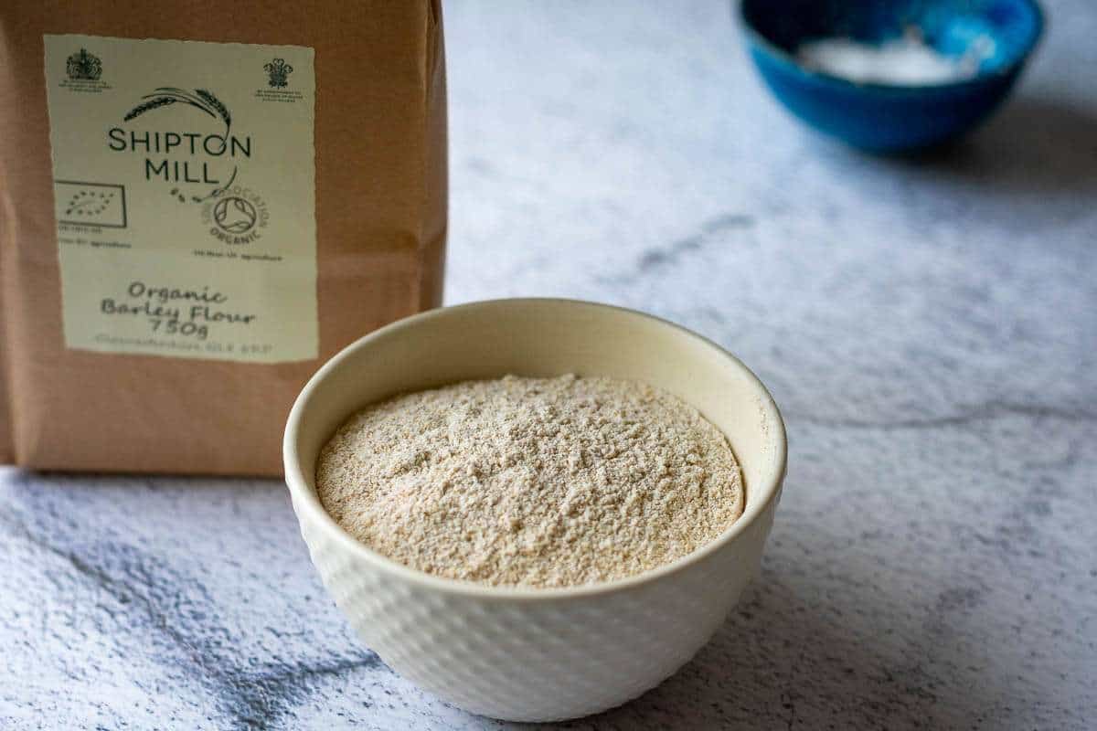 Barley flour in a small white bowl.