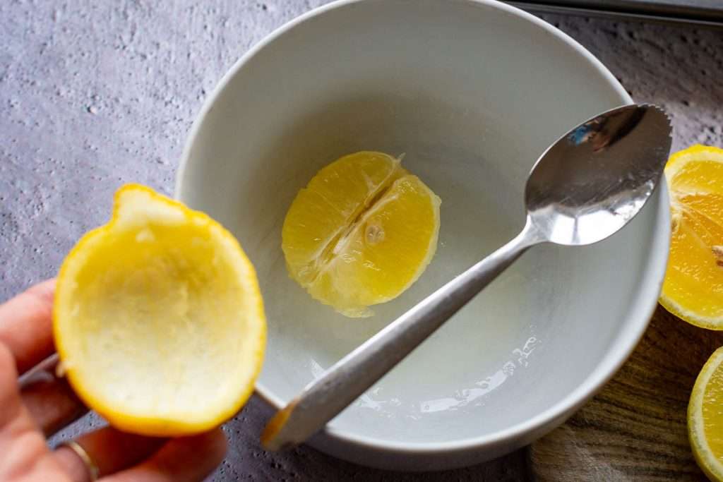 half of the lemon peel with the lemon flesh scooped out of it.