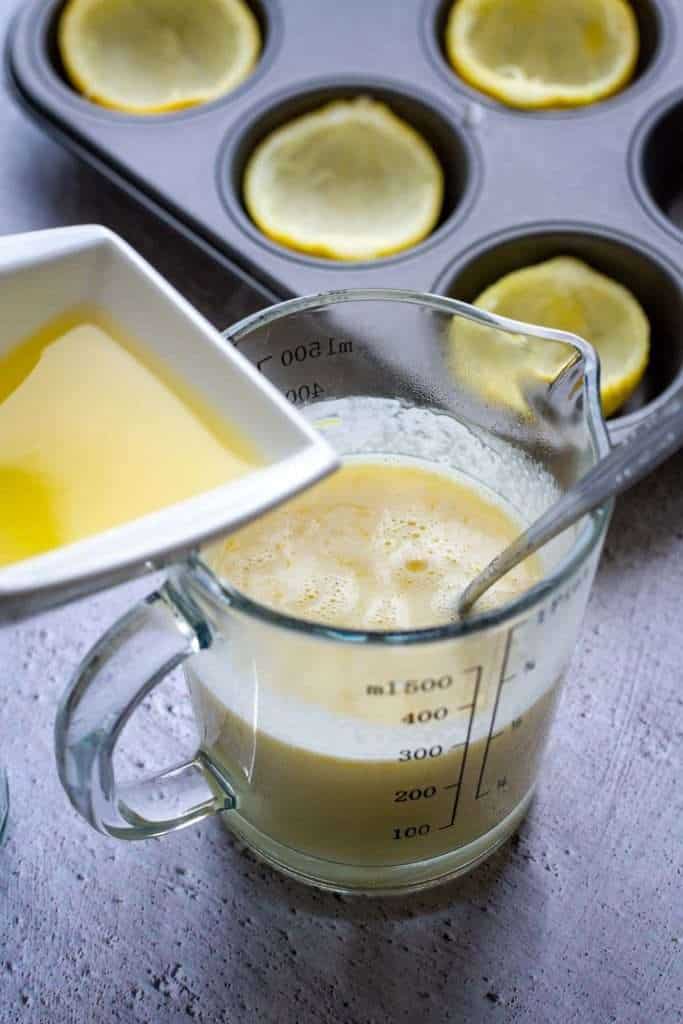 Gradually adding lemon juice to the cream mixture.