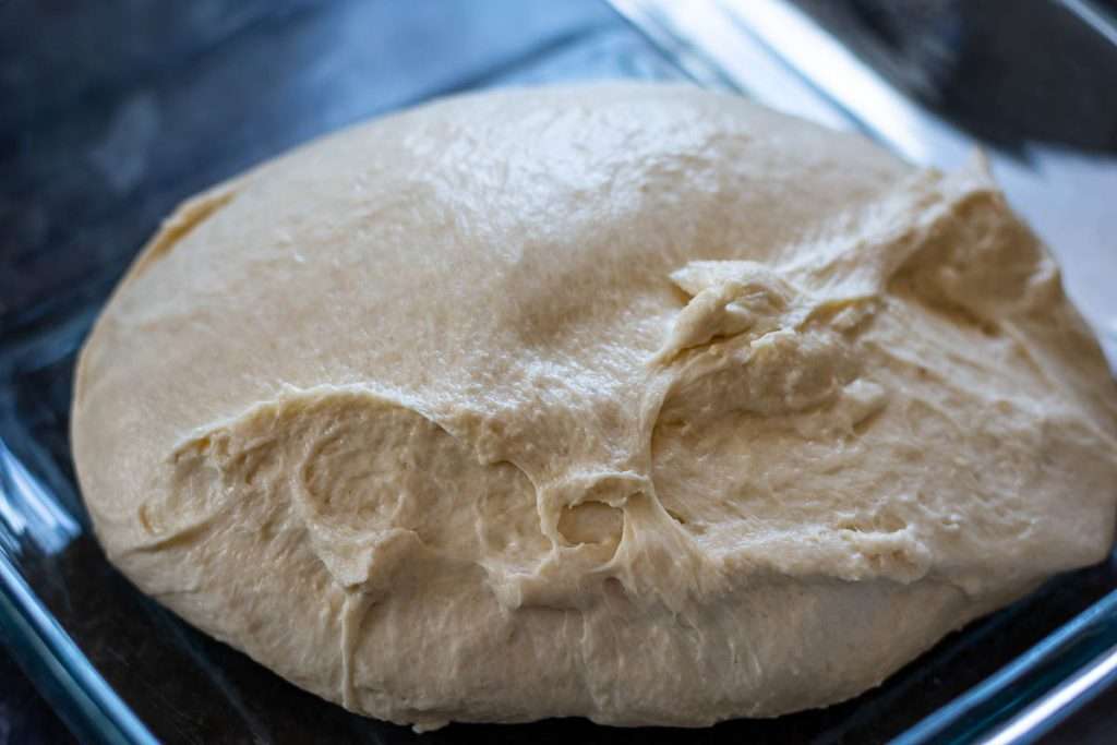 Sourdough before coil folds in a glass dish.