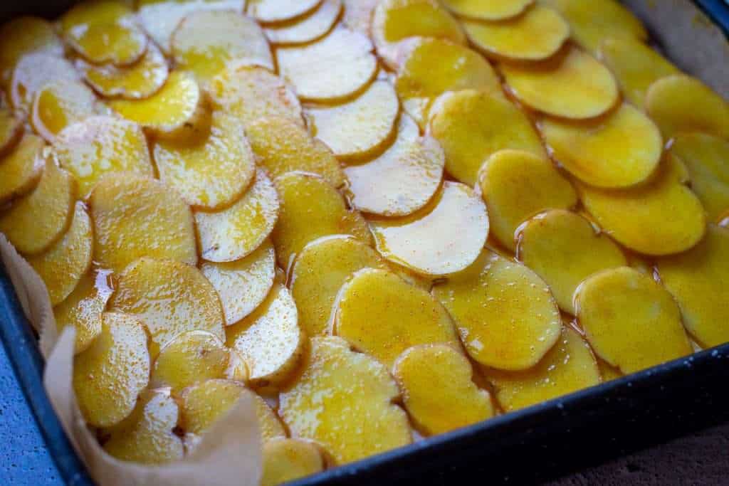 Potato topping brushed with turmeric oil.