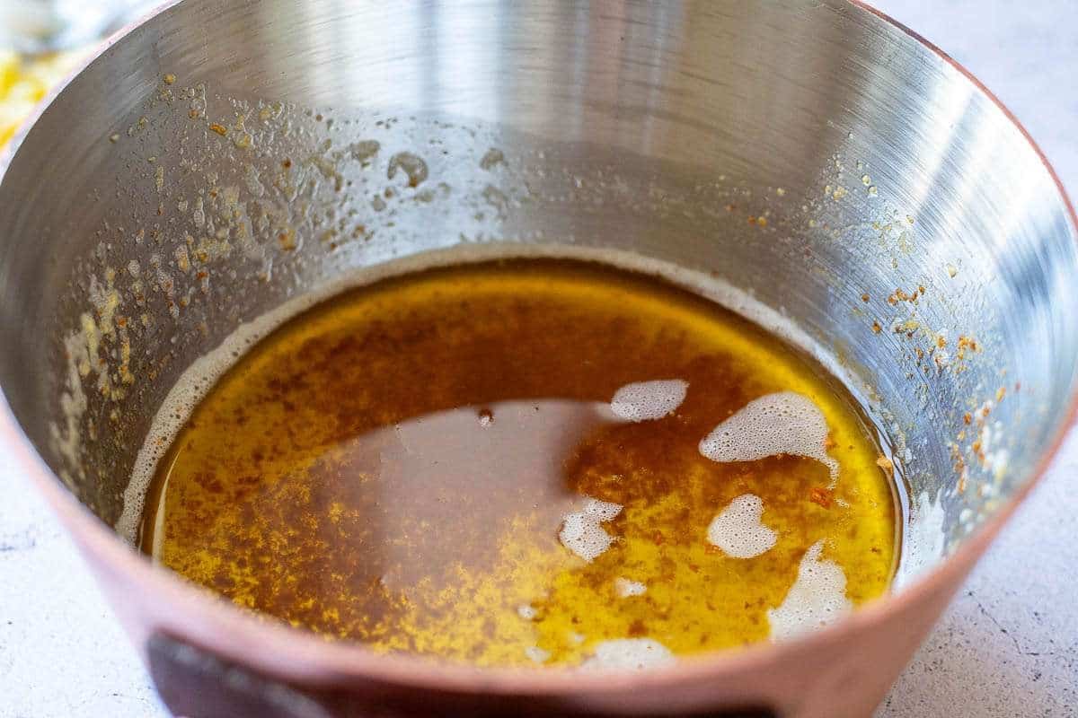 Browned butter in a copper pan.