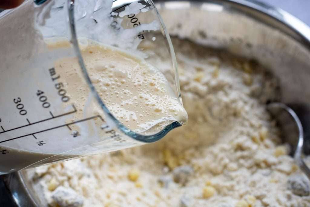 Pouring the discard mixture into the dry ingredients.