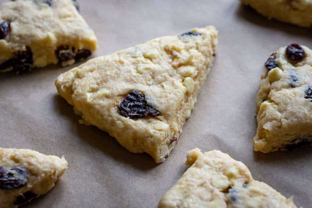 Sourdough Cherry scones arranged on a baking sheet lined with parchment paper.