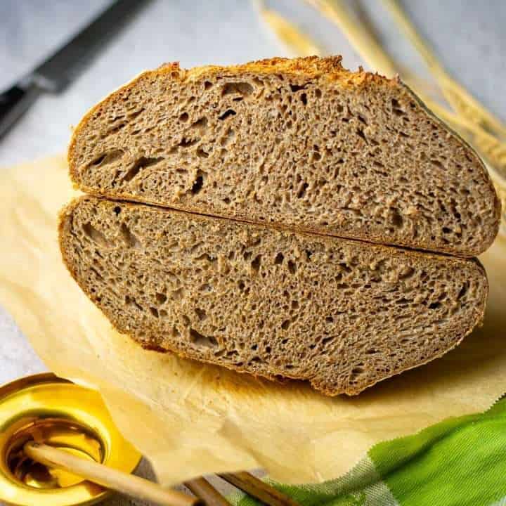 Sourdough bread made with 100% whole wheat flour cut in half.