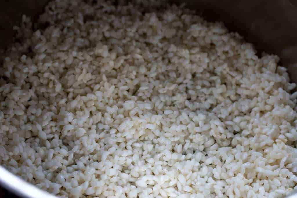 Rinsed sushi rice in a pan.