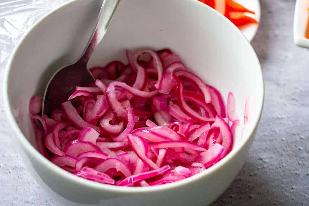 Bright pink pickled red onion.
