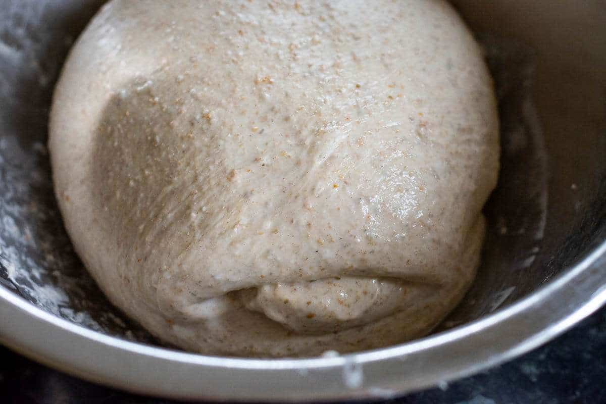 Coil folded French sourdough in a large bowl.