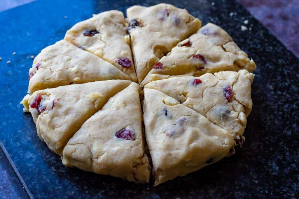 A circle of scone dough cut into 8 wedges.