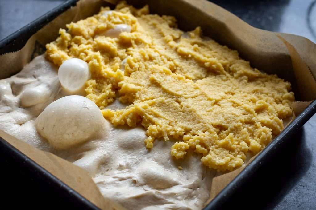 Frangipane filling spread on half of the focaccia dough.