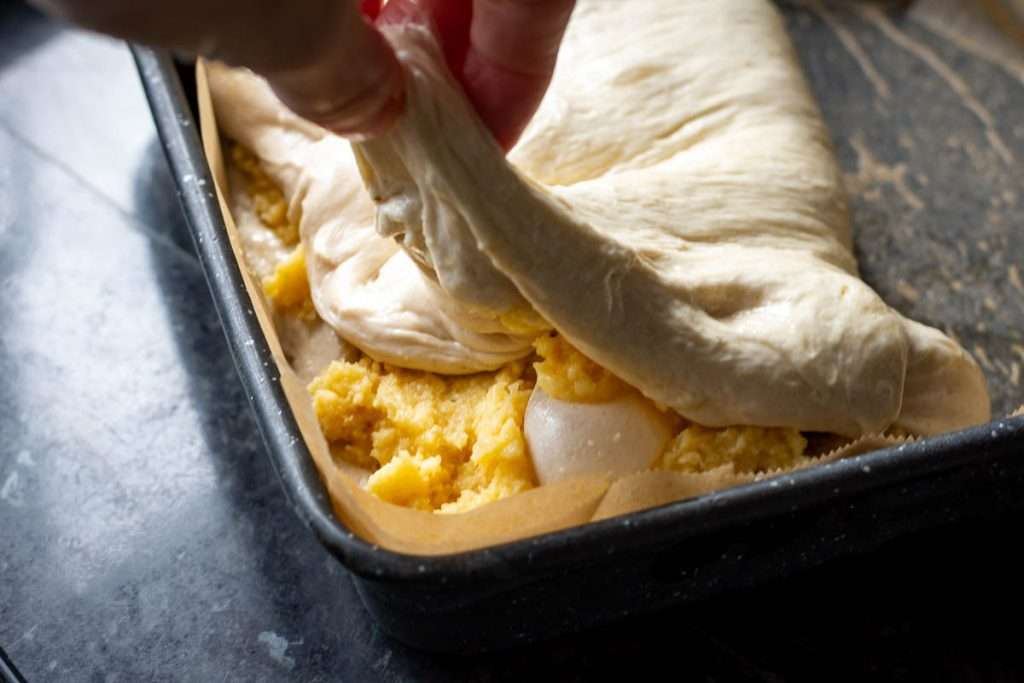 Folcing the dough over the almond filling.